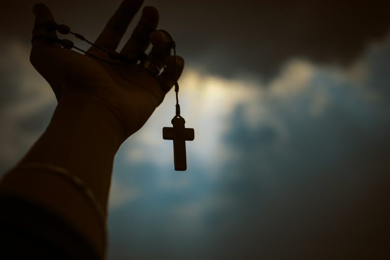person holding rosary